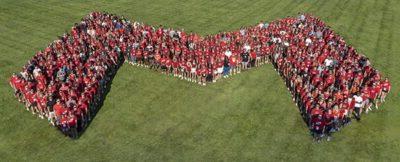 On-campus students at Maryville University stand in Big Red M formation